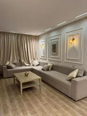 a living room with a couch and a coffee table at Séjour agréable in Oulad Akkou