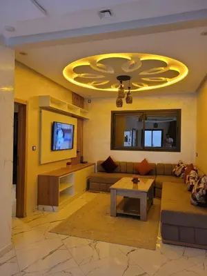 a living room with a couch and a tv at Bella Nova Air-Conditioned Apartment in Azrou