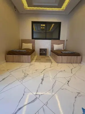 a room with two beds and a fireplace at Bella Nova Air-Conditioned Apartment in Azrou