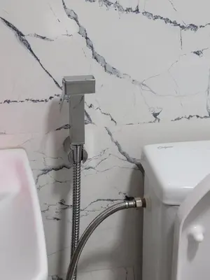 a bathroom with a hose hooked up to a toilet at Bella Nova Air-Conditioned Apartment in Azrou