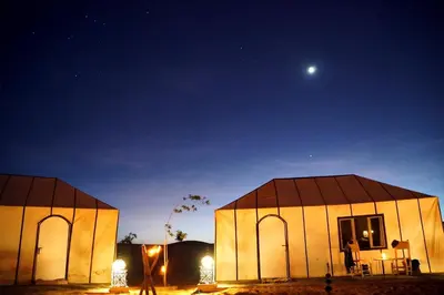 two domes at night with the moon in the sky at Starlit Desert Camp in Foum Zguid