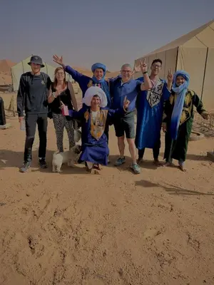 a group of people dressed up in costumes with a dog at Starlit Desert Camp in Foum Zguid
