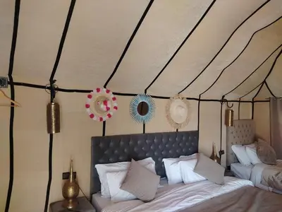 a bedroom with a bed in a tent at Siman luxury camp in Merzouga