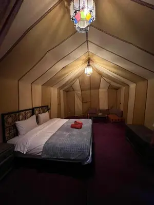 a bedroom with a bed in a tent at Siman luxury camp in Merzouga