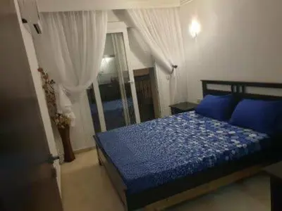 a bedroom with a blue bed with blue pillows at sabri in Beni Mellal