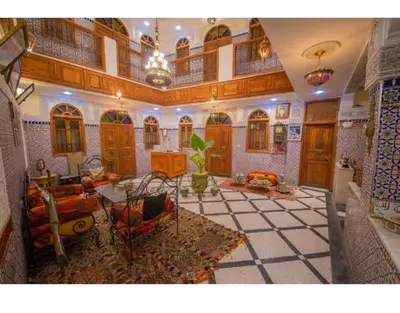 a living room with a couch and a table at Riad Haddaji fez in Fès
