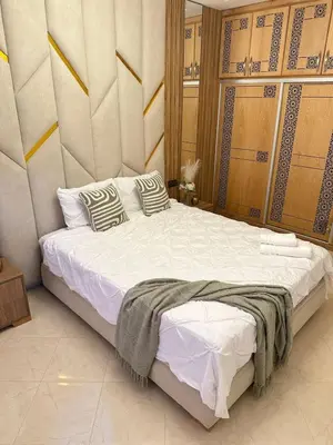 a bedroom with a large bed with white sheets and pillows at Chic & Cozy Apartment for a Comfortable Stay Fes in Fès