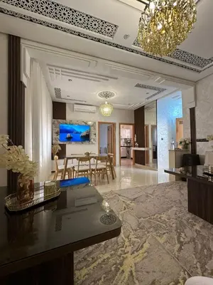 a living room with a table and a dining room at Chic & Cozy Apartment for a Comfortable Stay Fes in Fès