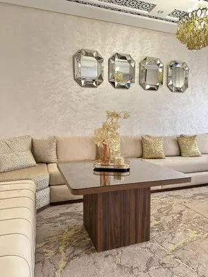 a living room with a couch and a table and mirrors at Chic & Cozy Apartment for a Comfortable Stay Fes in Fès