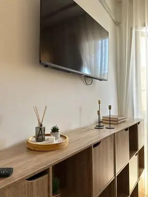 a flat screen tv hanging on a wall at Chic & Cozy Apartment for a Comfortable Stay Fes in Fès