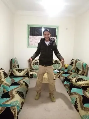 a person standing in a room with chairs at Hassan's Guest House in Mhamid