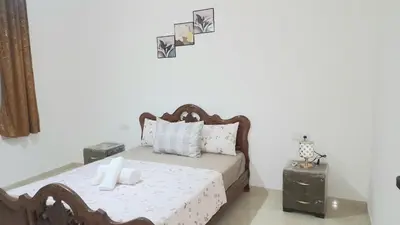 a bedroom with a bed with two night stands at City escapade apartement in Fès