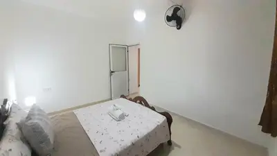 a bedroom with a bed with a table in it at City escapade apartement in Fès