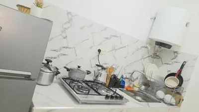 a kitchen counter with a sink and a stove at City escapade apartement in Fès