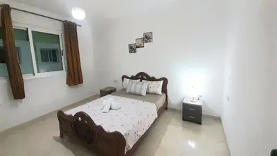 a bedroom with a bed in a room with a window at City escapade apartement in Fès