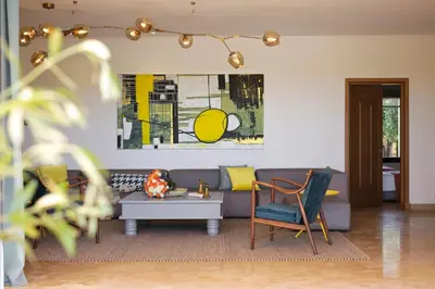 a living room with a couch and a table at Salamouni Villa ideal for family, 4-6 chambres, 8-12 personnes in Oulad Snaguia