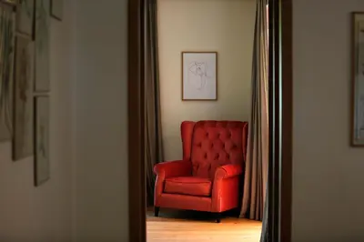 a red chair in a room with a mirror at Salamouni Villa ideal for family, 4-6 chambres, 8-12 personnes in Oulad Snaguia