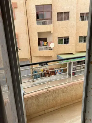 a balcony with a view of a building at Appartement calme et spacieuse in Meknès