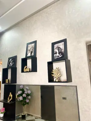 a group of framed pictures on a wall at Casa Kush in Sidi Bouzguia