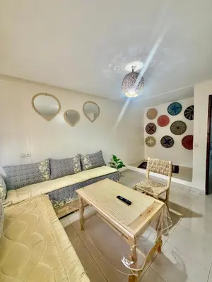 a living room with a couch and a table at Family house in Ourika