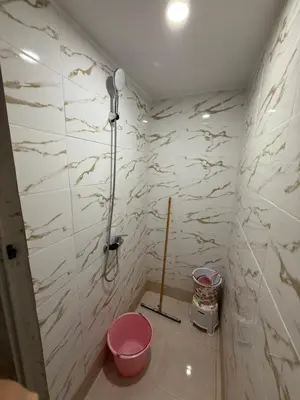 a bathroom with a shower and a pink toilet at Family house in Ourika