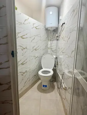 a small bathroom with a toilet in a stall at Family house in Ourika