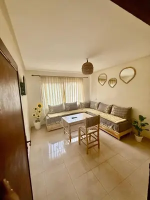 a living room with a couch and a table at Family house in Ourika