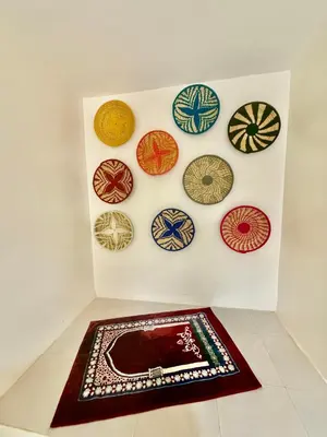 a wall with a bunch of plates on a wall at Family house in Ourika