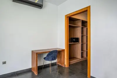 a room with a desk and a chair next to a wall at Red villa, pool not overlooked in Oulad Akkou