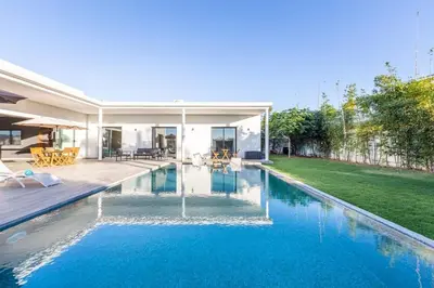 a swimming pool in the backyard of a house at Luxury villa, private heated pool, jacuzzi, games in Oulad Akkou