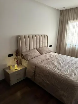 a bedroom with a large bed and a window at Appartement de luxe au coeur de Casa in Oulad Akkou