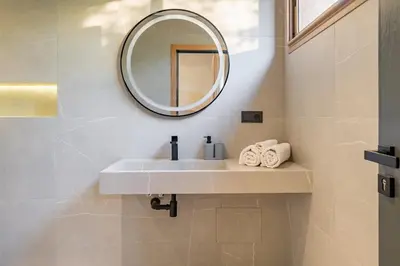 a bathroom with a sink and a mirror at New villa k, heated pool, Hammam in Oulad Akkou
