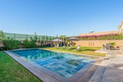 a swimming pool in the yard of a building at New villa k, heated pool, Hammam in Oulad Akkou