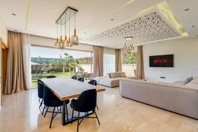 a living room with a table and a couch at New villa k, heated pool, Hammam in Oulad Akkou