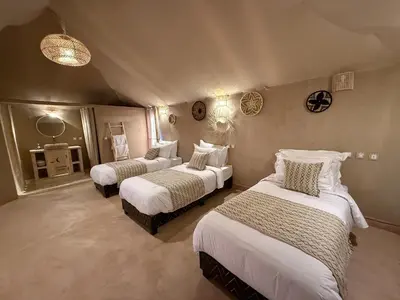 a bedroom with two beds in a room at lunara camp in Merzouga