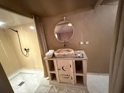 a bathroom with a sink and a mirror at lunara camp in Merzouga