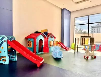 a play room with a slide and a playground at Cocon Elégant CFC, Pool, Gym & Parking Gratuit in Oulad Akkou