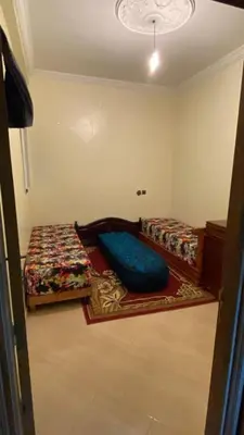 a room with two beds in a room at Belle appartement et spacieuse in Meknès