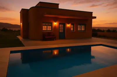 a villa with a pool in front of a house at Tazouta Farm Villa with Private Pool & Mountain Views in Tazouta