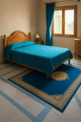 a bedroom with a bed with a blue blanket on it at Tazouta Farm Villa with Private Pool & Mountain Views in Tazouta