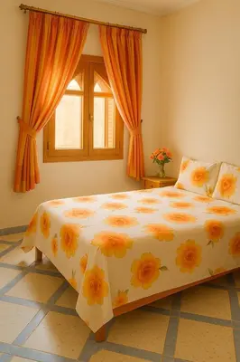 a bedroom with a large bed with flowers on it at Tazouta Farm Villa with Private Pool & Mountain Views in Tazouta