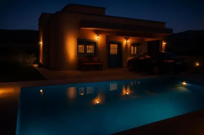 a night view of a swimming pool in front of a house at Tazouta Farm Villa with Private Pool & Mountain Views in Tazouta