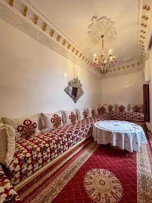 a living room with a couch and a chandelier at Dar Noor Fès in Fès