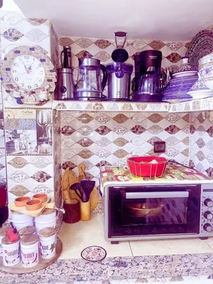 a microwave sitting on a kitchen counter with pots and pans at Dar Noor Fès in Fès