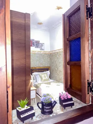 a bedroom with a bed and two potted plants at Dar Noor Fès in Fès