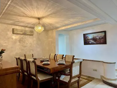 a dining room with a wooden table and chairs at Chic & Spacious 4BR with Jacuzzi-Fez New City Stay in Fès