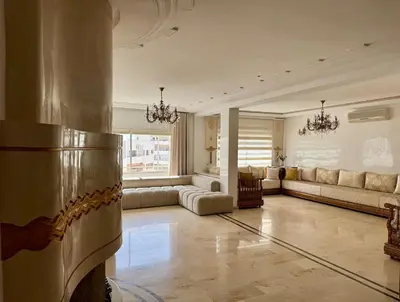 a large living room with couches and a large window at Chic & Spacious 4BR with Jacuzzi-Fez New City Stay in Fès