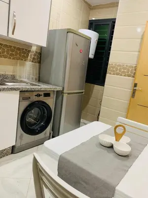 a kitchen with a washer and a washing machine at prestige appartment in Fès