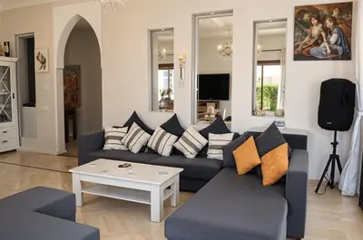 a living room with a couch and a table at Kridarek - Magnifique Villa avec piscine à Marrakech in Douar bel Rhanodour