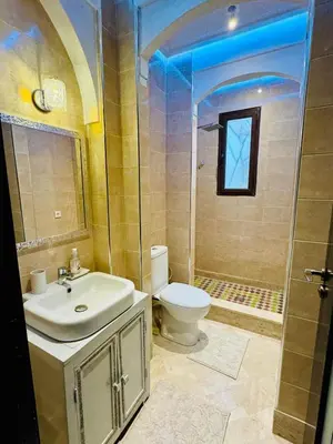 a bathroom with a sink and a toilet and a shower at Kridarek - Magnifique Villa avec piscine à Marrakech in Douar bel Rhanodour